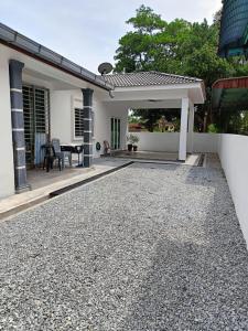 a patio of a house with a gravel driveway at Homestay Taiping Holiday FamilyDay Please Chat First Before Booking in Kamunting