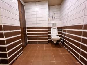 a bathroom with a toilet and a sink at GS COTTAGE ON MALL ROAD in Shimla