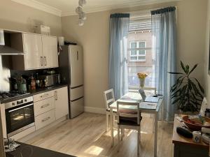 a kitchen with a table and a dining room at The Old Post Office Double Room (town centre) in Carnoustie