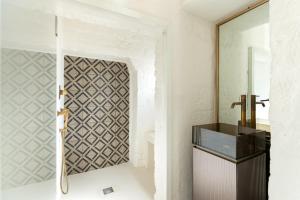 baño con espejo y lavabo en AL PALAZZO La Dimora by Apulia Hospitality, en Fasano