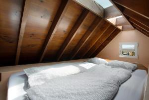 a bed in a room with wooden walls and a window at Casa Verde in Teguise