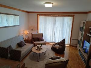 a living room with a couch and a table at Snježna Vila in Jahorina