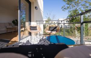 a balcony with two chairs and a table at Cosy, lumineux, proche du centre-ville in Caen