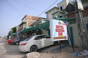 a white car parked in front of a building with a sign at Hotel Serina Inn in Kalar Goth