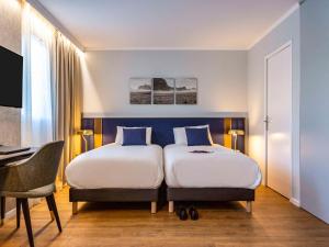 Postel nebo postele na pokoji v ubytování Mercure Toulouse Aeroport Blagnac