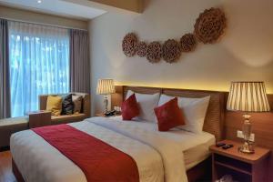 Rúm í herbergi á Ramada by Wyndham Yogyakarta