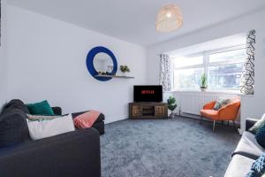 a living room with a couch and a tv at Cosy 3-Bedroom House Near City Centre with Free Parking in York