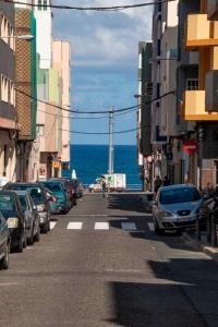 une rue de la ville avec des voitures garées sur le côté de l'océan dans l'établissement El Salvador 53, à Las Palmas de Gran Canaria