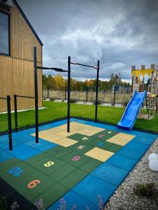 a playground with a blue slide in a park at Oaza Sobącz / Resort&Spa in Sobącz