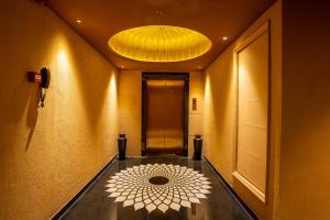 a hallway with a large chandelier and a hallway with a floor at Historia Royal in Udaipur