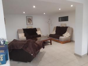 a living room with two couches and a coffee table at Les châtillonnes 25 minutes du zoo de beauval in Châtillon-sur-Indre