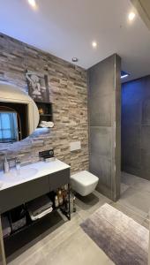 a bathroom with a sink and a toilet and a mirror at Ferienwohnung Bad Reichenhall Center in Bad Reichenhall