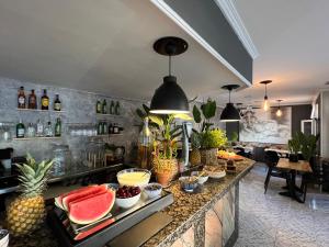 a kitchen with a counter with fruits and vegetables on it at Balear Hotel in Ciutadella