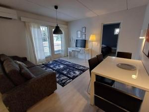 a living room with a couch and a table at Pikiruukin kruunu in Kokkola