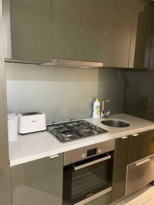 a kitchen with a stove and a sink at MEL 1BED Entire Apt next 2 Crown For 3PP in Melbourne