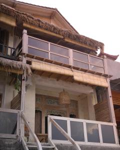 a house with a porch with glass doors on it at La Beach Penida in Nusa Penida