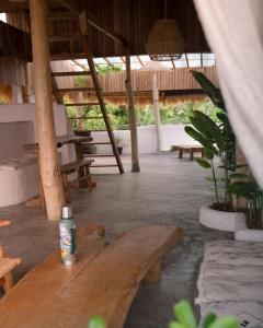 a wooden table with a drink sitting on top of it at La Beach Penida in Nusa Penida