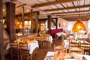 a restaurant with tables and chairs in a room at Hotel Restaurant Lathener Marsch in Lathen