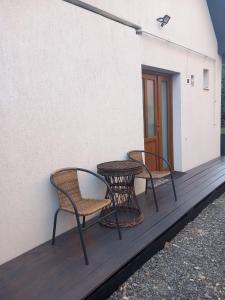 two chairs and a table on a porch at Happy Guests Residence in Sibiu