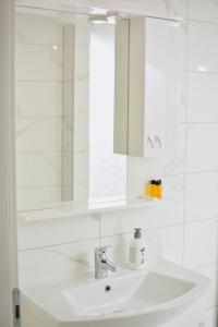ein Bad mit einem Waschbecken und einem Spiegel in der Unterkunft Hotel Divanhana in Brčko
