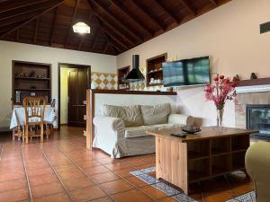 a living room with a couch and a table at RUSTIC HOUSE LA MONTAÑA in Breña Baja