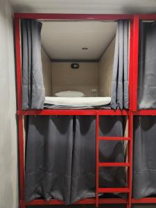 a room with a bunk bed on a red shelf at No.9 Hostel kanchanaburi in Ban Don Rak