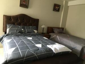 a bedroom with a large bed and a bedskirts at El Seminario Hospedaje in Cajamarca +2 photos