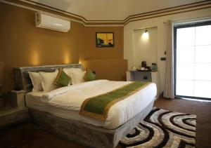 a bedroom with a large bed and a window at CLUB 21 by Sariska Fun City, Alwar in Mācheri +37 photos