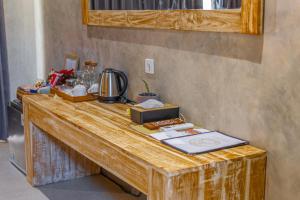 a wooden table with a counter top with items on it at Golden Garuda Cottages in Polilit