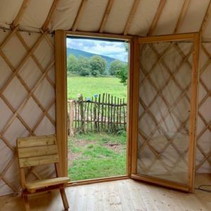 a large window in a yurt looking out at a field at Aughavannagh Yurt Glamping in Aughrim
