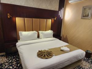 a hotel room with a bed with a bow on it at EWG Al Hamra Hotel in Jeddah