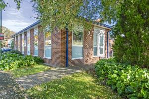 a brick house with a sidewalk in front of it at Brand New 1-Bed Flat With Free Parking in Nottingham