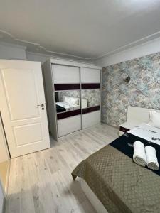 a bedroom with a bed and a sliding door at Garsoniera Cristina in Bucharest