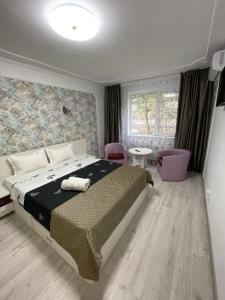 a bedroom with a large bed and a window at Garsoniera Cristina in Bucharest