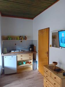 a kitchen with a white refrigerator and a table at Privat Alena in Harrachov