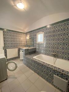 a bathroom with a tub and a toilet at Blue Beach Hostel in Soliman