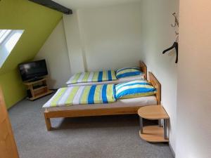 a small bedroom with a bed and a tv at Ferienwohnung Laux in Essen