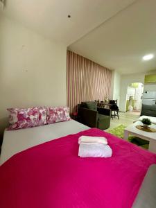 1 dormitorio con 1 cama grande con manta rosa en Lilly Skopje en Skopie