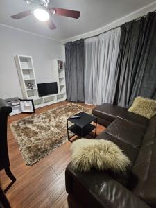 a living room with a leather couch and a rug at Royal Place 2 bedrooms Apartment Wilanów in Warsaw +19 photos