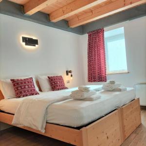 a bedroom with a large bed with towels on it at Cà Soldati in Campi