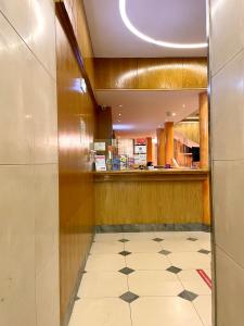 a restaurant with a counter and a tile floor at Hotel Universal in Porto