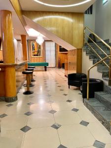 a lobby with a pool table and stairs at Hotel Universal in Porto