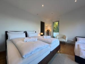 ein großes Schlafzimmer mit 2 Betten und einem Fenster in der Unterkunft LIBORIA I Stylisches Haus I Sauna I Wellness in Starnberg