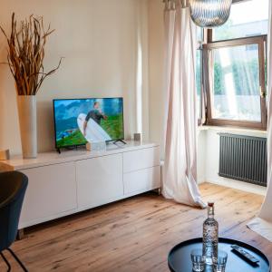 ein Wohnzimmer mit einem TV auf einem weißen Schrank in der Unterkunft M Apartment Charme - gemütlich geräumig heimisch in Landau in der Pfalz