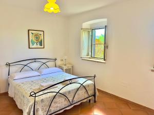 Postel nebo postele na pokoji v ubytování Carpine Agriturismo Bio in Maremma