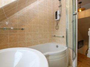 a bathroom with a tub and a toilet and a shower at 15 Main Street in Peterhead +27 photos
