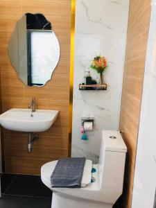 La salle de bains est pourvue de toilettes, d'un lavabo et d'un miroir. dans l'établissement Cher Cher Pool Villa, à Ban Chang