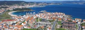 an aerial view of a city with a beach and water at Apartamento RUAL in Sanxenxo