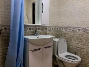 a bathroom with a sink and a toilet and a mirror at Бархат in Cholpon-Ata