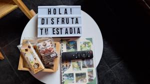 a book sitting on a table next to a keyboard at OSIMiRI ARENAL apartamento-Naturaleza-aventura-comodidad-Cine en casa in San Rafael +40 photos